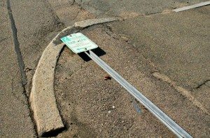 Street sign still down and out all but in the gutter in the Q  A Quincy Quarry News photo