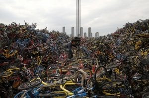Worker untangles a rope amid piled-up shared bikes at a vacant lot in Xiamen | Quincy News About Quincy Massachusetts