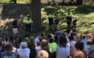 Quincy Community Police Officers cool off with Shaved Kona Ice before a bicycle safety presentation