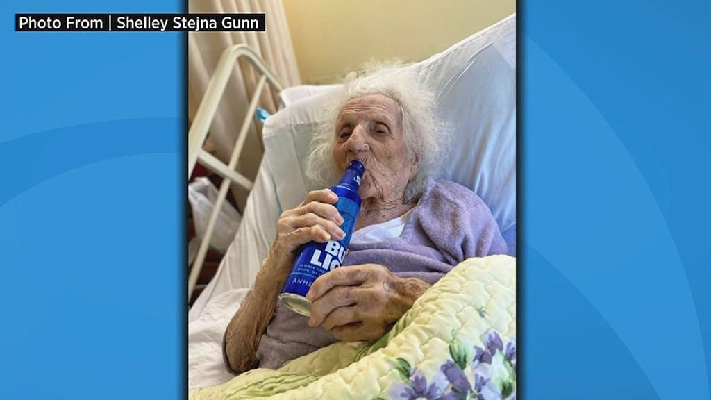 One Hundred and three year old enjoys a beer to celebrate her beating COVID-19